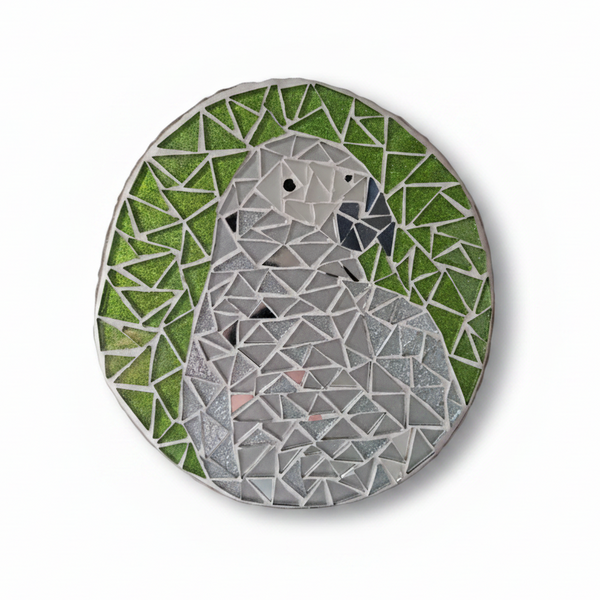 Grey parrot mosaic with silver mirror tiles and a glittery green background 