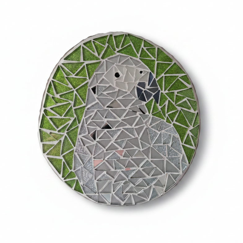 Grey parrot mosaic with silver mirror tiles and a glittery green background 