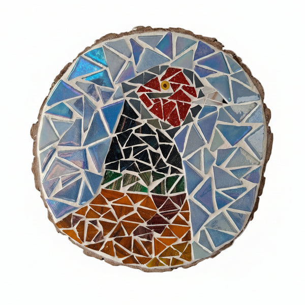 Circular mosaic wall art featuring a stylized pheasant design. Crafted with gold-dusted brown, green, red and bronze glass pieces on an iridescent blue background, set on rustic wood.