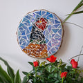 Pheasant mosaic on the wall surrounded by plants
