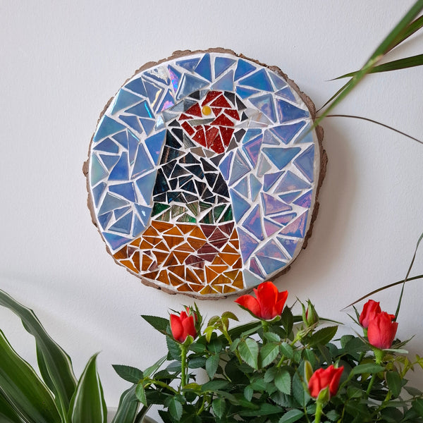 Pheasant mosaic on the wall surrounded by plants
