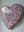 Side view of a heart shaped mosaic artwork, showing the rustic wood edge.
