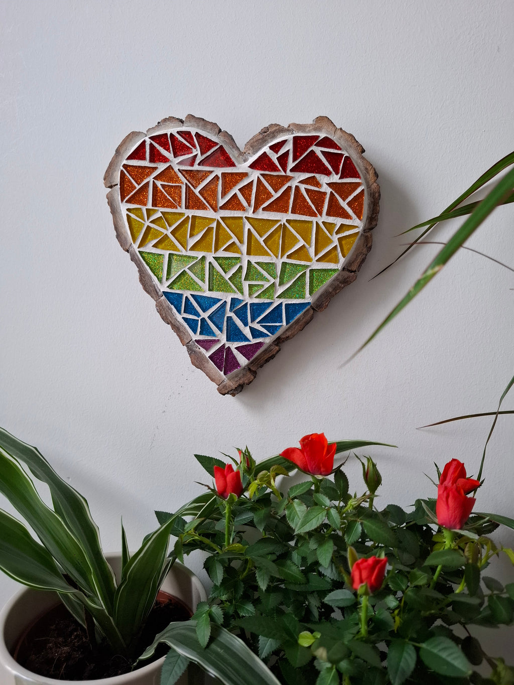 Heart mosaic on the table surrounded by plants