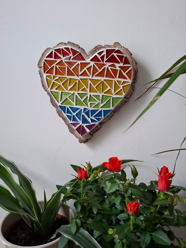 Heart mosaic on the table surrounded by plants