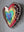 Side view of a heart shaped mosaic art piece with a rainbow pattern.