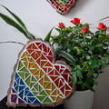 Heart mosaic on the table surrounded by plants