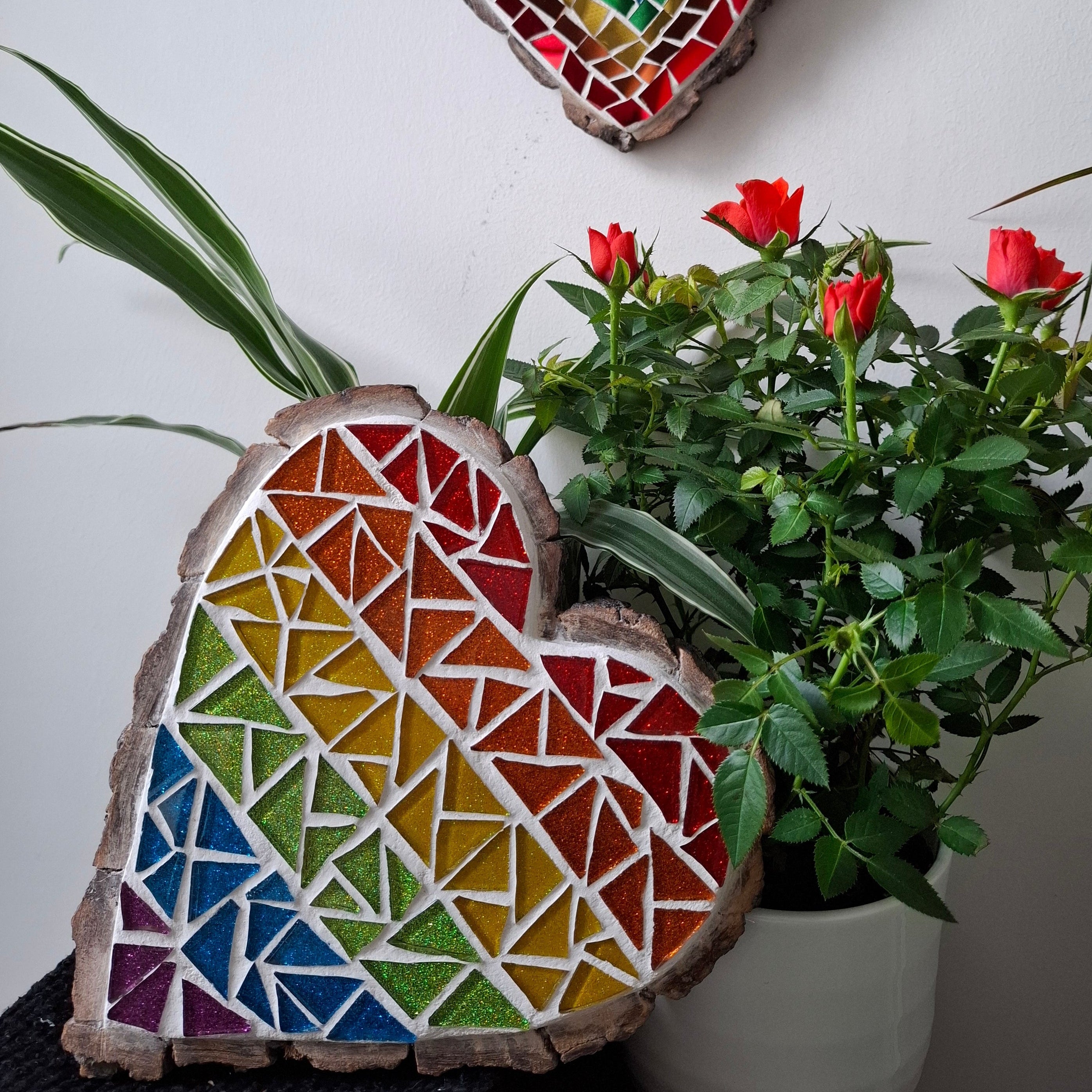Heart mosaic on the table surrounded by plants