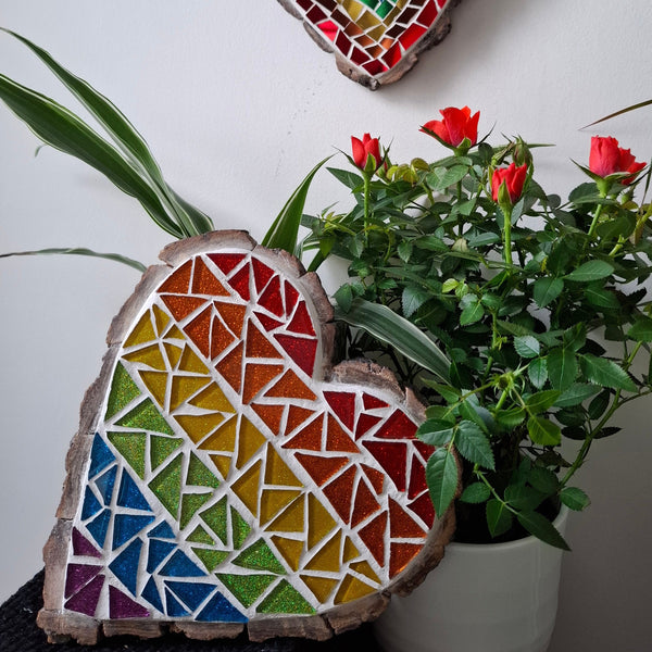 Heart mosaic on the table surrounded by plants