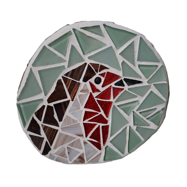 Circular mosaic wall art featuring a stylized robin design. Crafted with white, red, and brown glass pieces on a frosted aqua background, set on rustic wood.