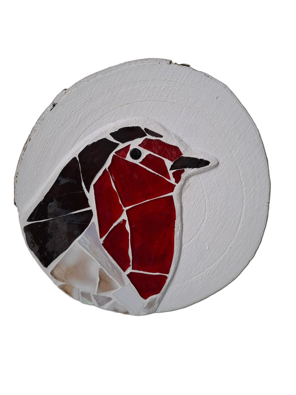 Circular mosaic wall art featuring a stylized robin design. Crafted with white, red, and brown stained glass pieces on a painted white background, set on rustic wood. 