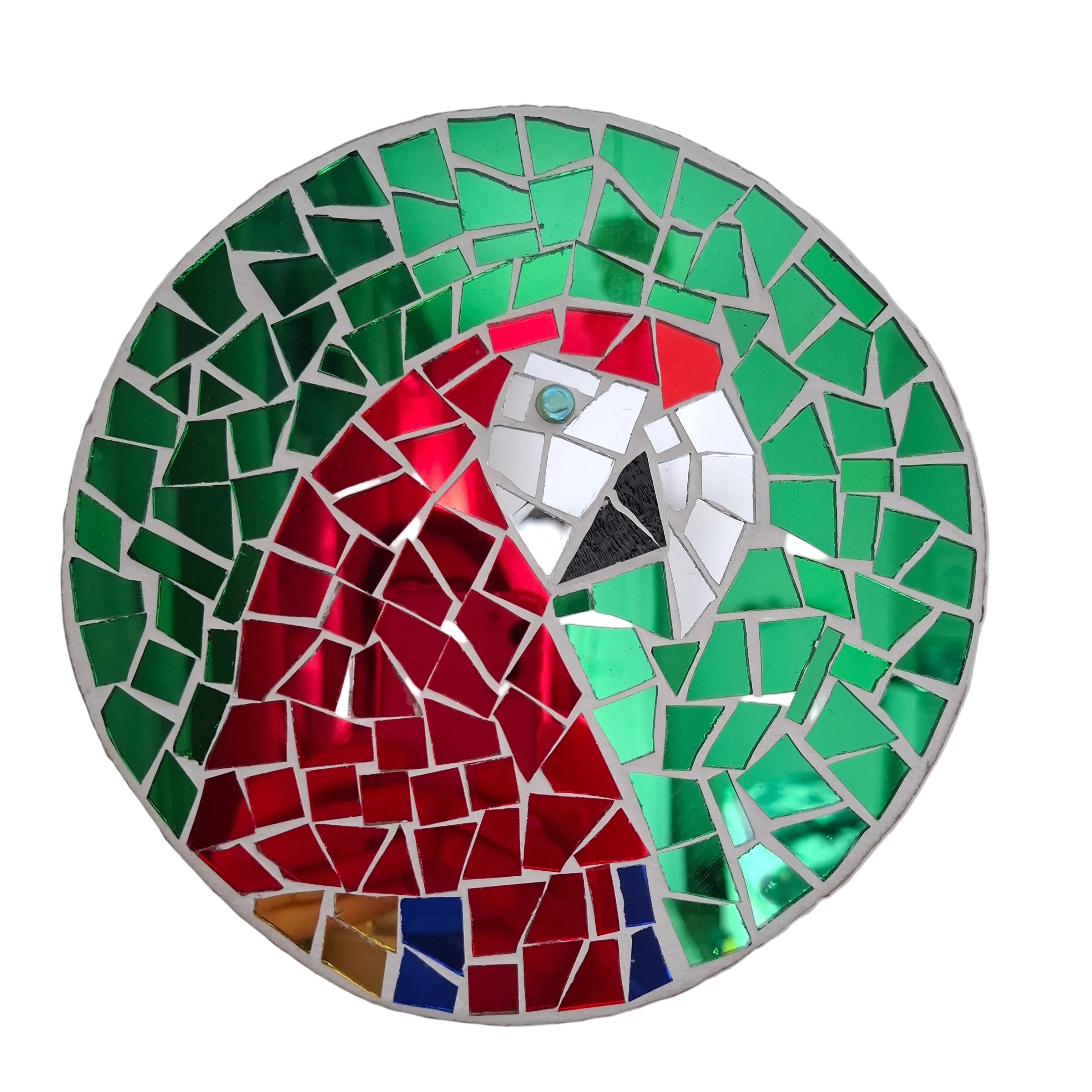 Circular mosaic wall art featuring a stylized macaw design. Crafted with reflective blue, red and gold mirror glass pieces on a reflective green mirror background, set on rustic wood.