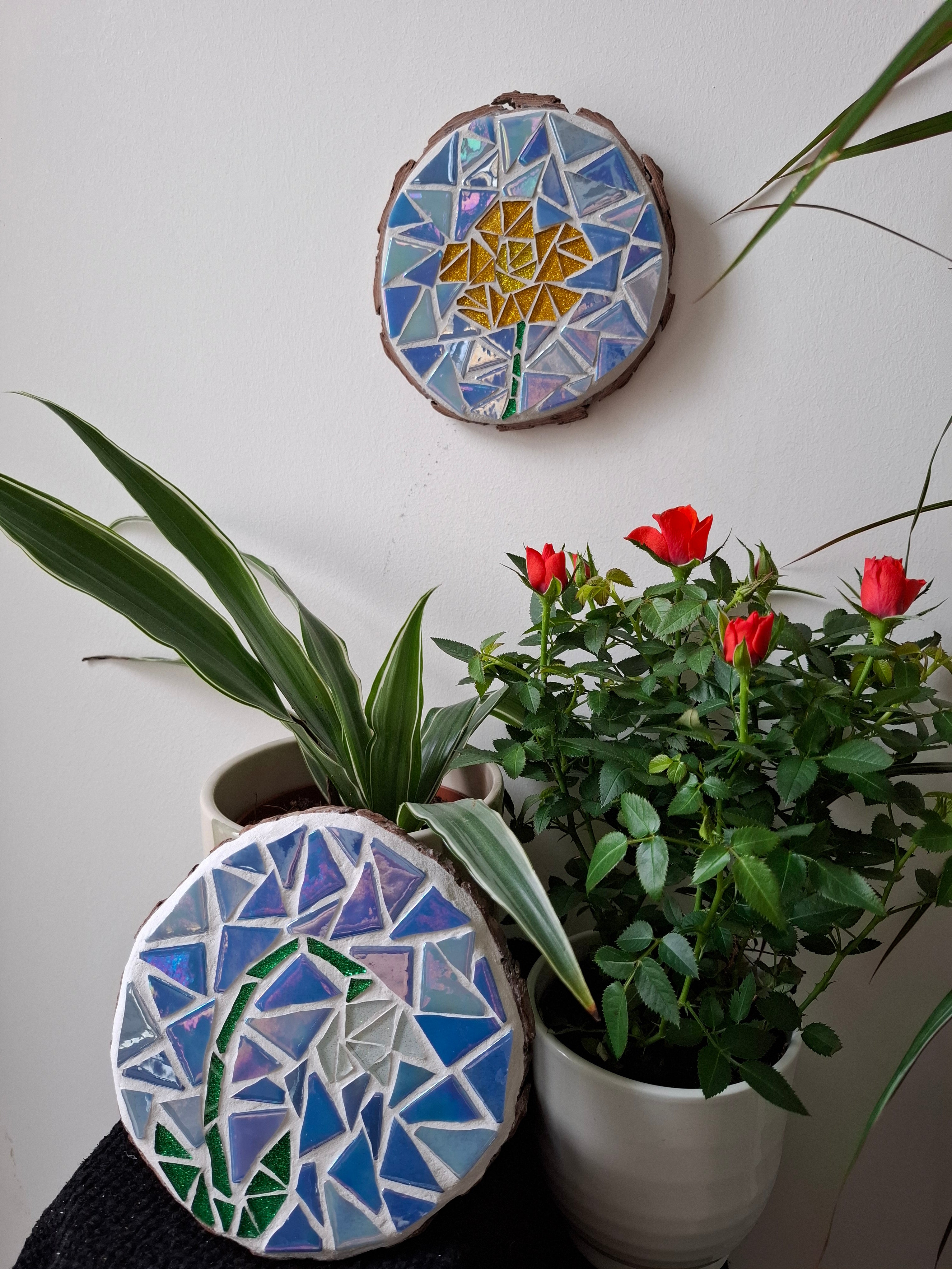 Flower mosaics on the wall surrounded by plants