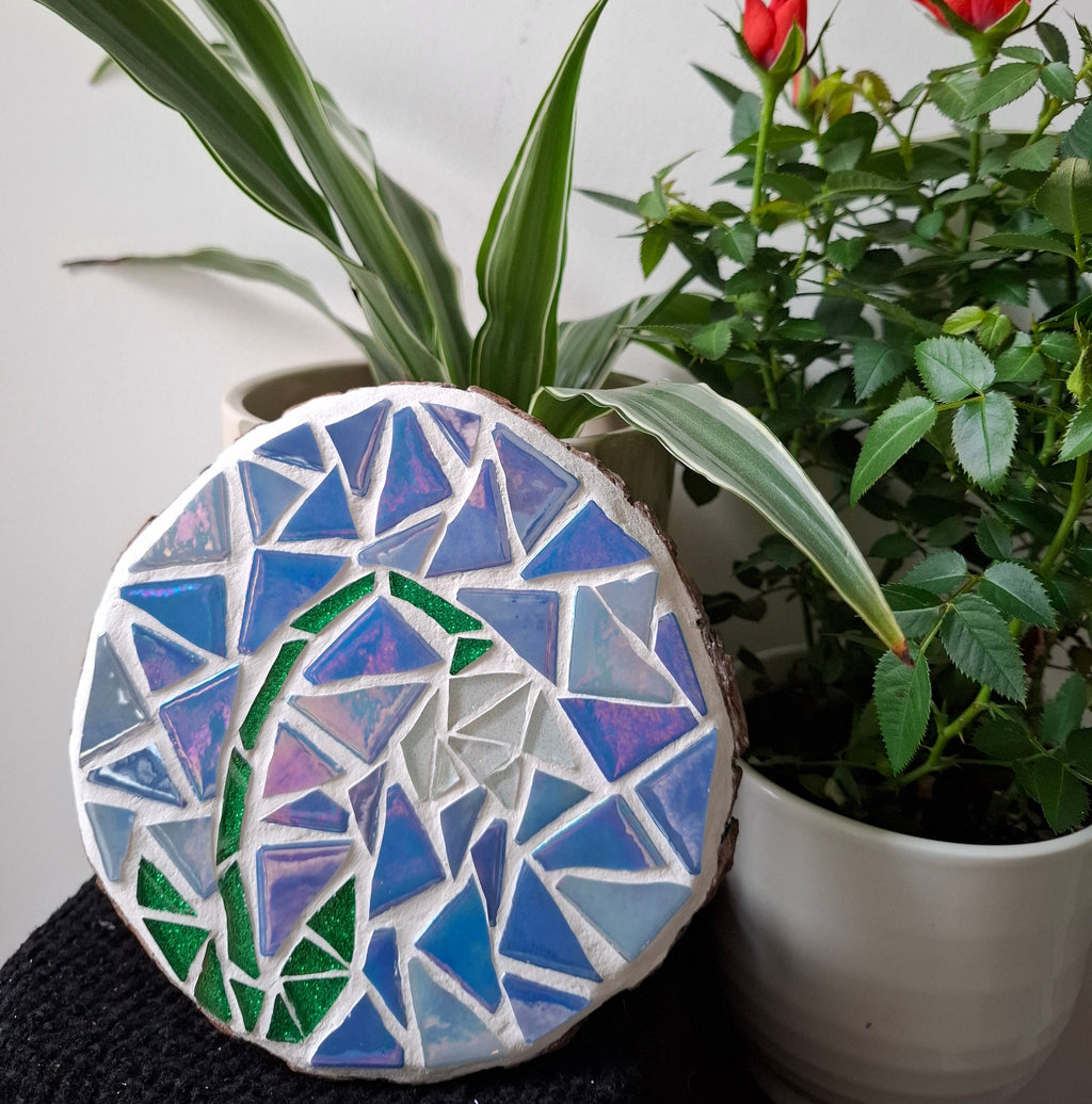 Snowdrop mosaic on the table surrounded by plants
