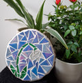 Snowdrop mosaic on the table surrounded by plants