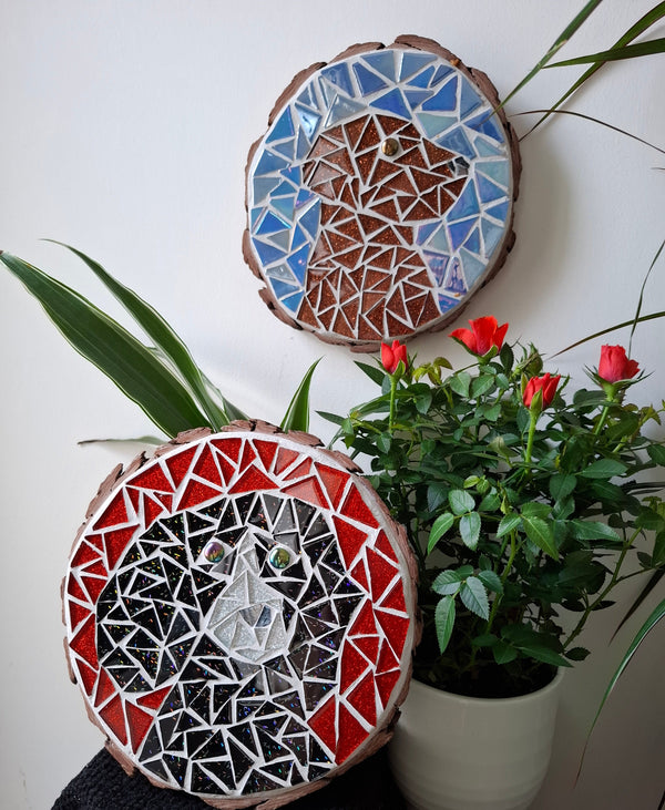 Dog mosaics on the wall surrounded by plants
