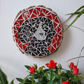 Dog mosaic on the wall surrounded by plants
