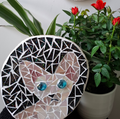 Cat mosaic on the table surrounded by plants
