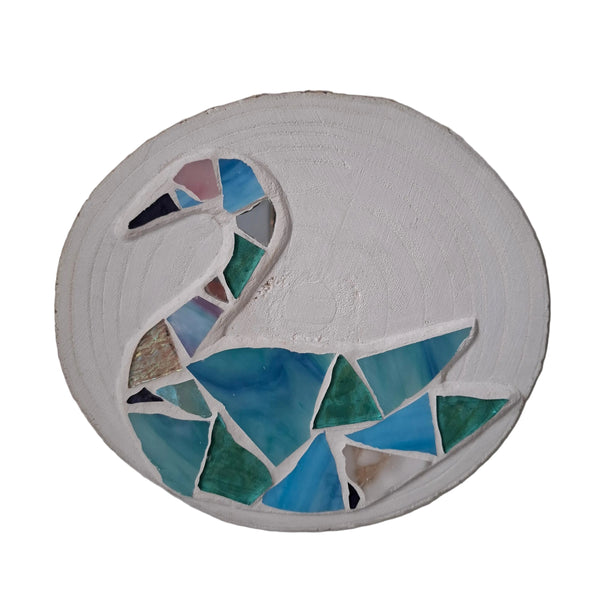 A circular mosaic wall art piece featuring a stylized swan made from blue, green, and aqua glass tiles, isolated on a white backdrop. 