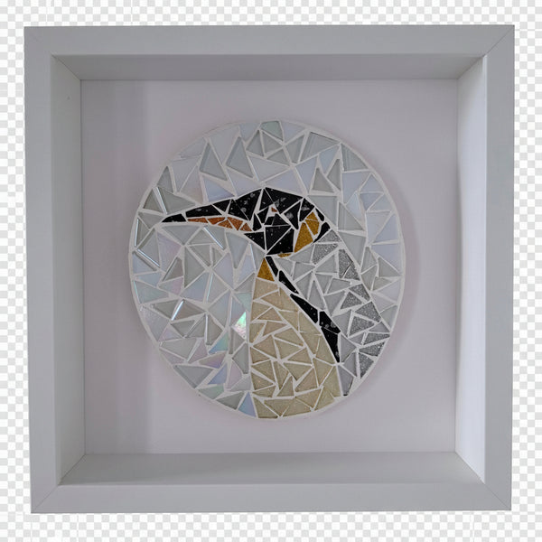 A circular mosaic wall art piece featuring a stylized penguin made of reflective mirrored glass tiles, mounted inside a square white shadow box frame.