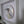 A circular mosaic wall art piece featuring a stylized penguin made of geometric glass tiles, mounted inside a white recessed wall frame.