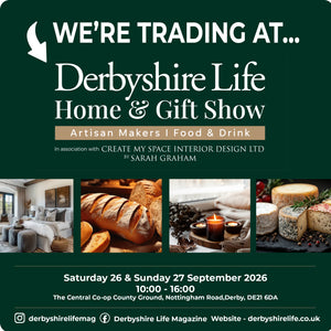 Promotional graphic for the Derbyshire Life Home & Gift Show, featuring a dark green background with white text, a white arrow, and three horizontal photo strips showing a living room, bread, candles, and cheeses. Event details for Saturday and Sunday 26 & 27 September 2026 are printed at the bottom.