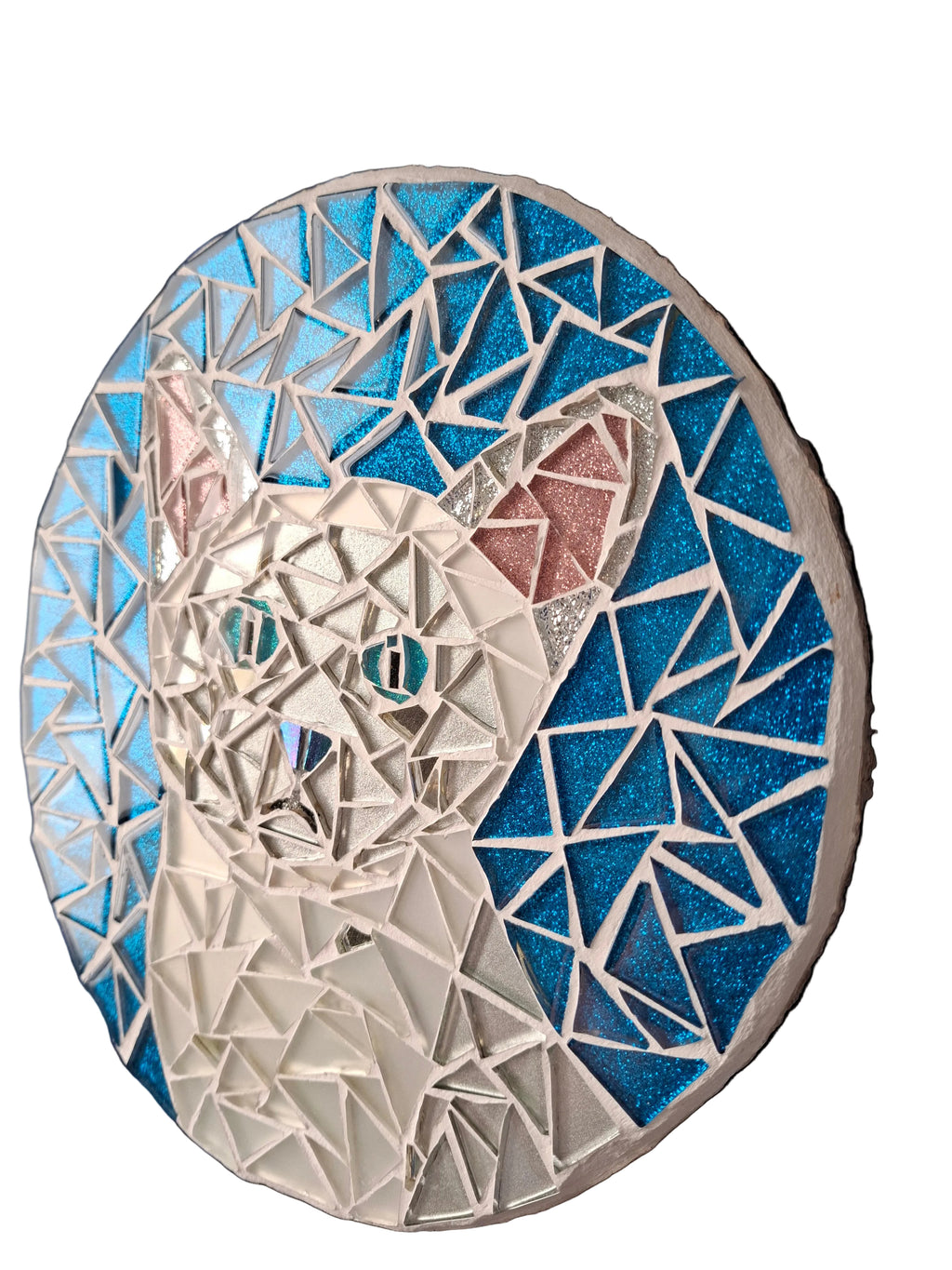 Side view of a circular cat mosaic artwork, showing the rustic wood edge.